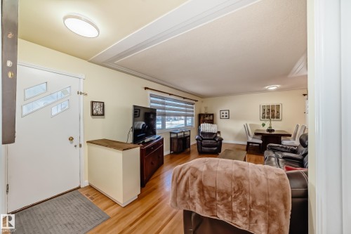 The property features hardwood floors and a white entry door with decorative glass inserts - 4446 116 Avenue, Edmonton, AB 