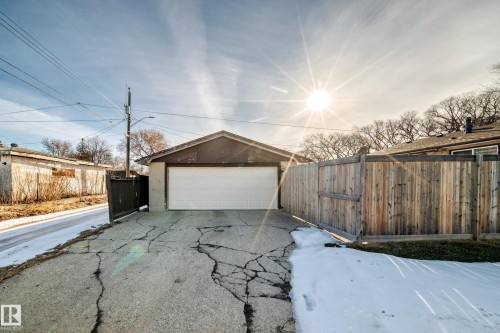 The property features a detached garage with a white garage door - 4446 116 Avenue, Edmonton, AB 