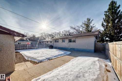 The property features a fenced yard, a paved area, and a detached structure - 4446 116 Avenue, Edmonton, AB 