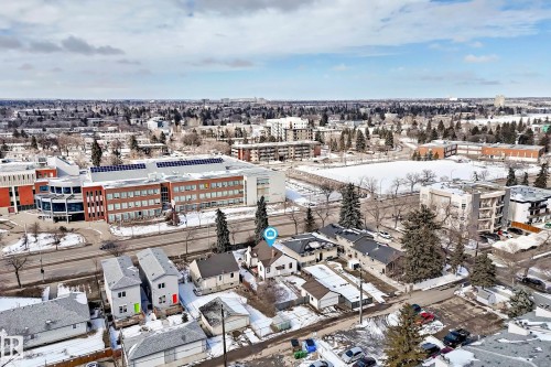 Aerial view showcasing the property situated within a developed urban area, featuring surrounding buildings and mature trees - 10839 109 Street, Edmonton, AB - Outdoor With View