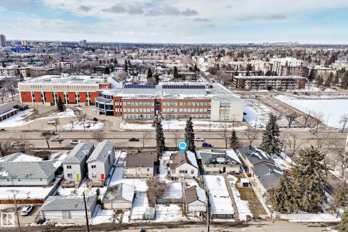 Aerial view showcasing the property within a neighborhood featuring other residential buildings and proximity to a larger commercial or institutional building - 10839 109 Street, Edmonton, AB - Outdoor With View