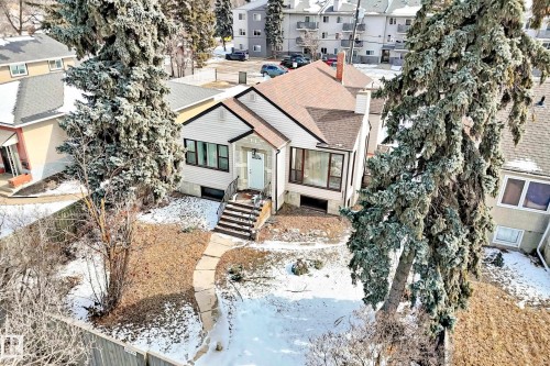 This property features a single-story home with a light-colored exterior and a brown roof - 10839 109 Street, Edmonton, AB - Outdoor