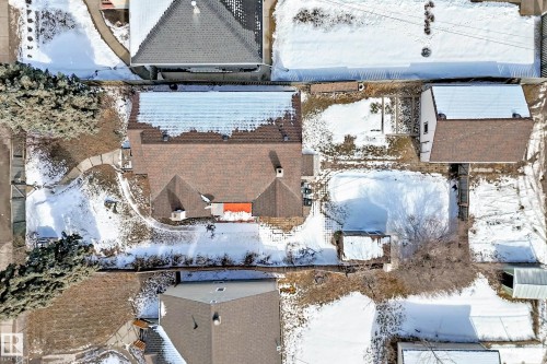 Aerial view showcasing the property's brown shingled roof, a paved walkway, and a large yard area - 10839 109 Street, Edmonton, AB - Outdoor