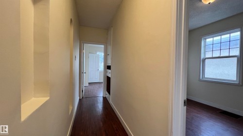 Hallway with dark hardwood flooring and built-in wall niches - 10839 109 Street, Edmonton, AB - Indoor Photo Showing Other Room