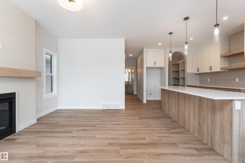 8 Tenuto Link, Spruce Grove, AB - Indoor Photo Showing Kitchen With Fireplace