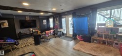 Living area featuring recessed lighting, exposed ceiling beams, and light-toned flooring - 