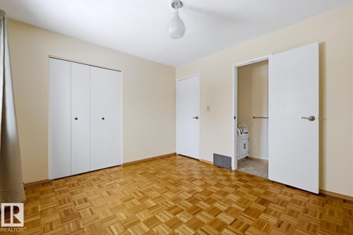 This room features light-colored walls, patterned wood flooring, and a ceiling light fixture - 16108 100 Street, Edmonton, AB - Indoor Photo Showing Other Room