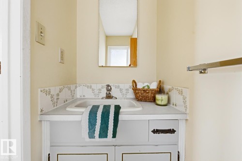 Bathroom vanity with an integrated sink and countertop - 16108 100 Street, Edmonton, AB - Indoor Photo Showing Laundry Room