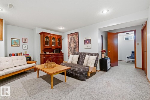 The living space features light gray walls, recessed lighting, and carpeting - 16108 100 Street, Edmonton, AB - Indoor Photo Showing Living Room