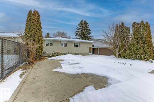 The property features a concrete paved area and a spacious yard - 16108 100 Street, Edmonton, AB - Outdoor
