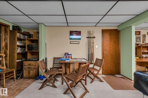 This versatile area features a drop ceiling, light-colored walls, and a combination of carpeted and hard flooring surfaces - 60017 Range Road 42, Rural Barrhead County, AB - Indoor