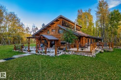 The property features a log cabin style exterior with a prominent A-frame roof - 