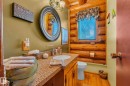 Bathroom featuring a wood vanity with a speckled countertop and a single sink - 60017 Range Road 42, Rural Barrhead County, AB  - Indoor Photo Showing Bathroom 