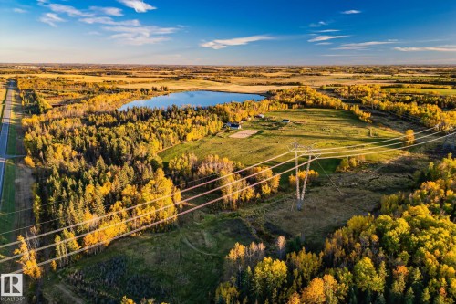 Expansive aerial view showcasing a large body of water, extensive tree coverage with vibrant autumn foliage, and clear skies - 60017 Range Road 42, Rural Barrhead County, AB - Outdoor With View