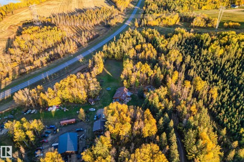 This property is situated amidst extensive areas of trees, featuring both deciduous and evergreen varieties - 60017 Range Road 42, Rural Barrhead County, AB - Outdoor With View