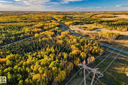 Expansive aerial view showcasing vibrant autumn foliage and a clear blue sky - 60017 Range Road 42, Rural Barrhead County, AB - Outdoor With View
