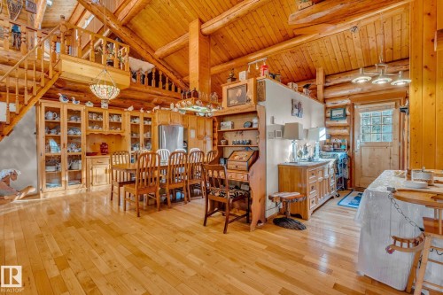 This property features extensive wooden beams, a wooden staircase, and light-toned hardwood flooring - 60017 Range Road 42, Rural Barrhead County, AB - Indoor Photo Showing Other Room