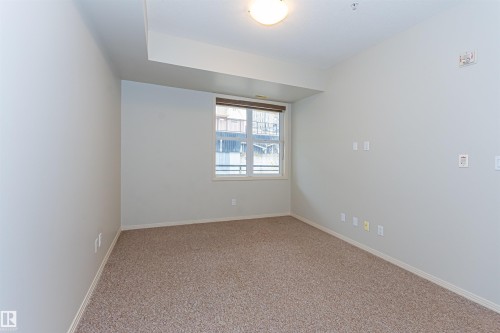 This room features neutral-toned carpet, light walls, and a window with blinds - 415 10503 98 Avenue, Edmonton, AB - Indoor Photo Showing Other Room