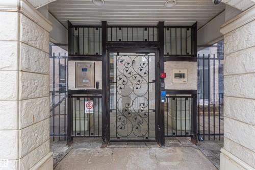 The property features a gated entryway with ornate ironwork and security access panels - 415 10503 98 Avenue, Edmonton, AB -  With Exterior