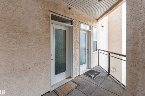 The property features a private entrance with a white door and textured glass, complemented by a secondary window - 415 10503 98 Avenue, Edmonton, AB - Outdoor With Balcony With Exterior