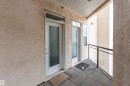 The property features a private entrance with a white door and textured glass, complemented by a secondary window - 415 10503 98 Avenue, Edmonton, AB  - Outdoor With Balcony With Exterior 