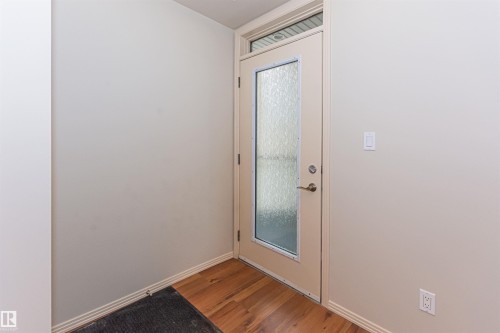 Entryway featuring hardwood floors and a door with frosted glass and a transom window - 415 10503 98 Avenue, Edmonton, AB - Indoor Photo Showing Other Room