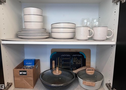 Upper and lower kitchen cabinet storage with adjustable shelving - 1701 10024 Jasper Avenue, Edmonton, AB - Indoor
