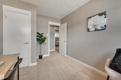 This room features neutral-toned walls, light-colored carpet, and white trim - 13211 104 Street, Edmonton, AB - Indoor
