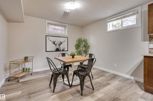 The property features light-colored walls, a ceiling light fixture, and windows providing natural light - 13211 104 Street, Edmonton, AB - Indoor Photo Showing Dining Room