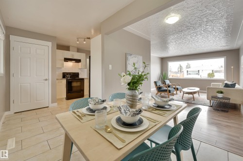 The dining area features light-colored flooring and a dining table with chairs - 13211 104 Street, Edmonton, AB - Indoor Photo Showing Dining Room