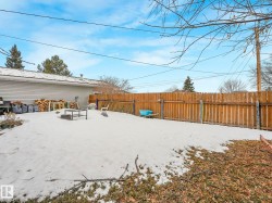 The property features a fenced yard with a visible fire pit area - 