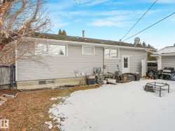 The property features grey horizontal siding and a dark shingled roof - 