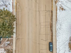 Aerial view of the street with a sidewalk and a tree - 