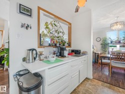 This property features a white countertop with white cabinetry, offering functional storage - 