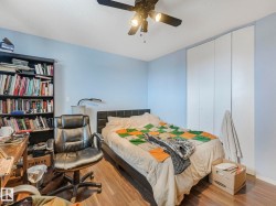 The property features wood-style flooring, a ceiling fan, and light blue walls - 