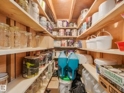 This storage space features extensive wooden shelving - 