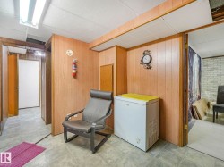 Utility room featuring wall paneling and overhead fluorescent lighting - 