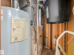 The utility area includes a hot water heater and a furnace - 