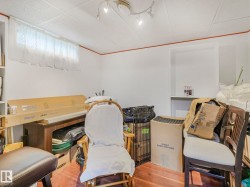 Room featuring white walls with red trim, a drop ceiling, and recessed lighting - 
