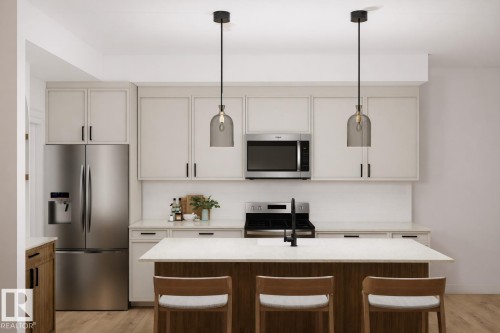 The kitchen features white cabinetry, stainless steel appliances, and a central island with a light-colored countertop - 16 Grayson Green, Stony Plain, AB - Indoor Photo Showing Kitchen With Upgraded Kitchen