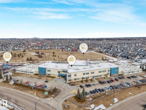 Aerial view of the surrounding neighborhood with residential properties, open land, and a school - 8112 Summerside Grande Boulevard, Edmonton, AB - Outdoor With View