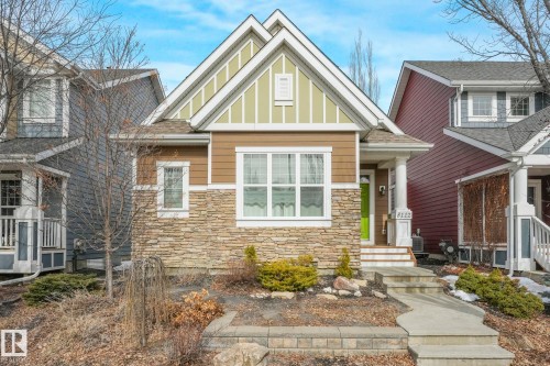 The property features a charming exterior with a stone facade, horizontal siding, and decorative gables - 8112 Summerside Grande Boulevard, Edmonton, AB - Outdoor With Facade