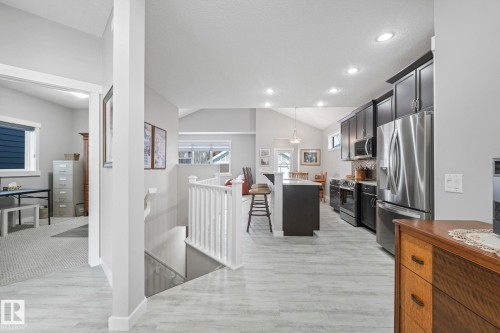 The property features an open-concept living space with light-toned flooring and vaulted ceilings - 8112 Summerside Grande Boulevard, Edmonton, AB - Indoor Photo Showing Other Room