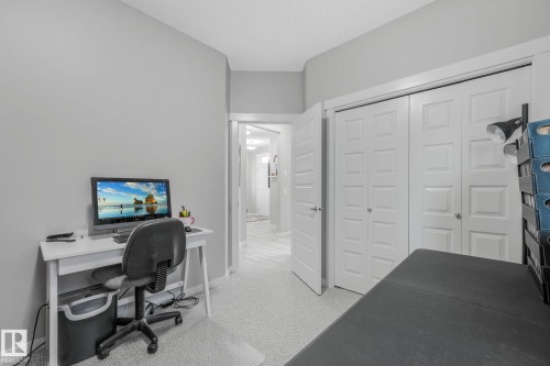 This room features light grey walls and carpeted flooring - 8112 Summerside Grande Boulevard, Edmonton, AB - Indoor Photo Showing Other Room
