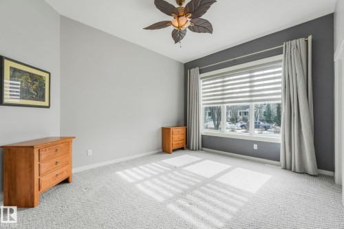 This bright room features a large window with blinds and curtains, offering views of the outdoors - 8112 Summerside Grande Boulevard, Edmonton, AB - Indoor