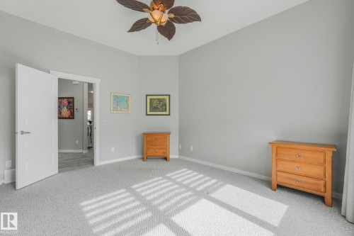 The room features soft gray carpeting and light gray walls, creating a neutral and inviting atmosphere - 8112 Summerside Grande Boulevard, Edmonton, AB - Indoor