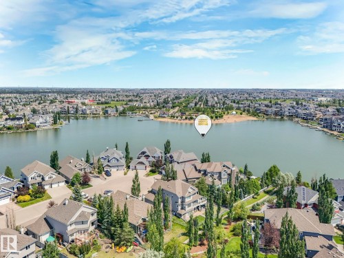 This property offers a serene lake view with surrounding residences and lush green landscaping - 8112 Summerside Grande Boulevard, Edmonton, AB - Outdoor With Body Of Water With View