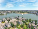 This property offers a serene lake view with surrounding residences and lush green landscaping - 8112 Summerside Grande Boulevard, Edmonton, AB  - Outdoor With Body Of Water With View 