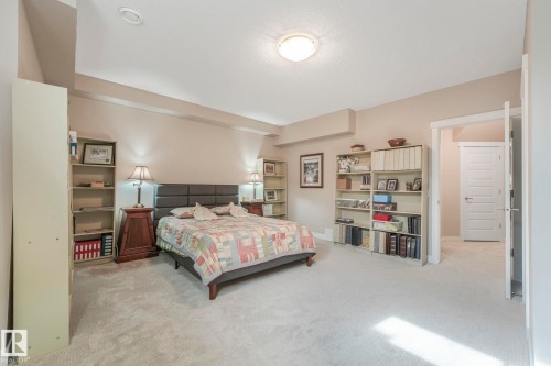 This room features light-colored carpeting, neutral painted walls, and overhead lighting - 8112 Summerside Grande Boulevard, Edmonton, AB - Indoor Photo Showing Bedroom