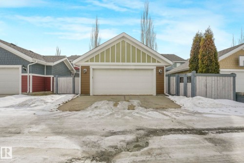 This property features a single-car garage with a white door and light green siding on the gable - 8112 Summerside Grande Boulevard, Edmonton, AB - Outdoor